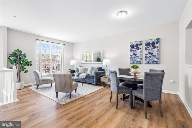 dining space with light wood-type flooring