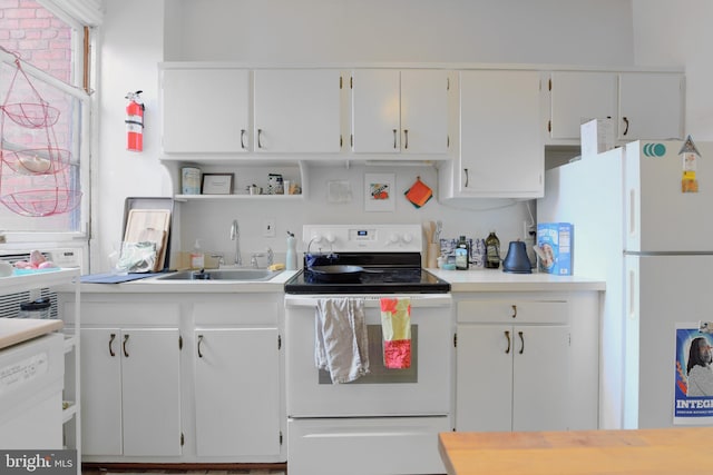 kitchen with light countertops, open shelves, white cabinetry, and white appliances