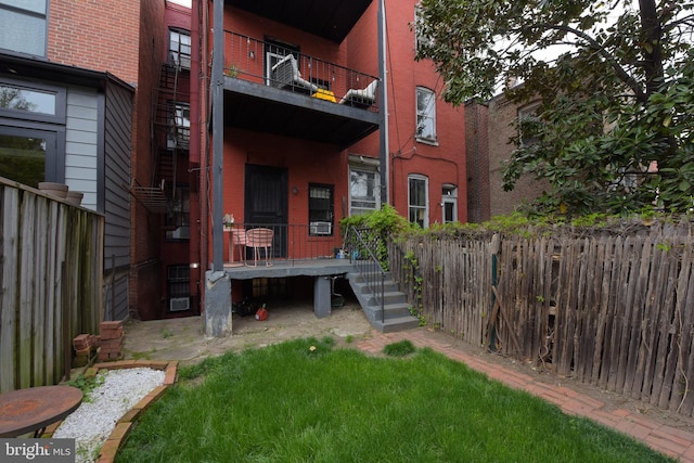 exterior space with a balcony and fence