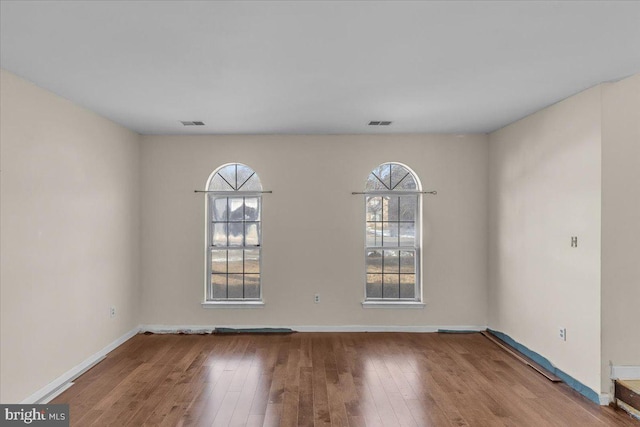 empty room featuring hardwood / wood-style floors and a healthy amount of sunlight