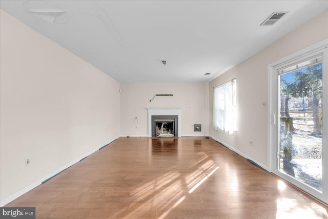 unfurnished living room featuring wood-type flooring