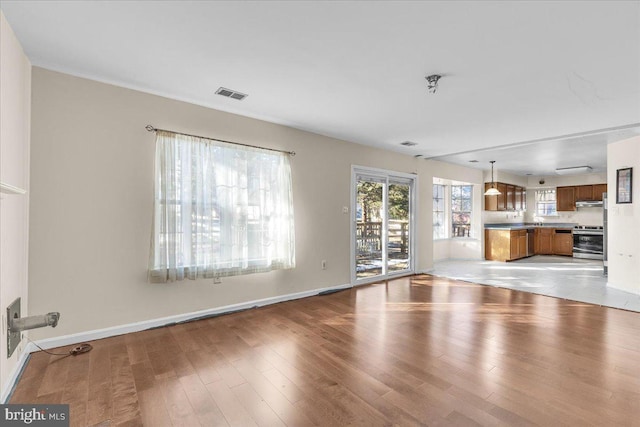 unfurnished living room featuring light wood-type flooring