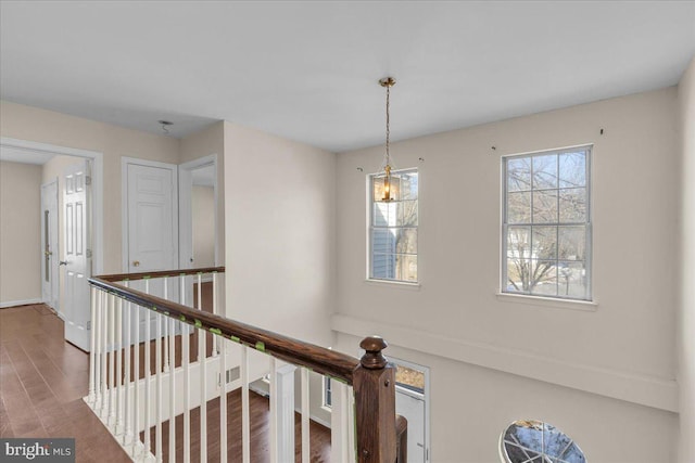 hallway with hardwood / wood-style floors