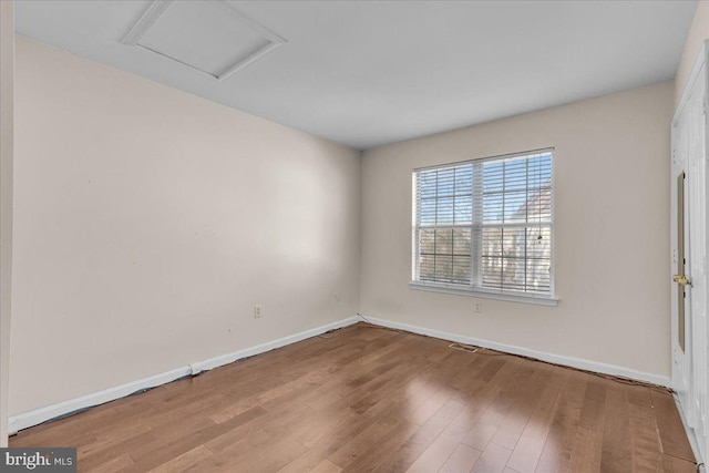 spare room with hardwood / wood-style floors