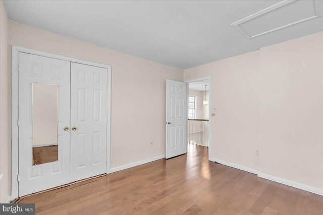 unfurnished bedroom featuring hardwood / wood-style floors and a closet