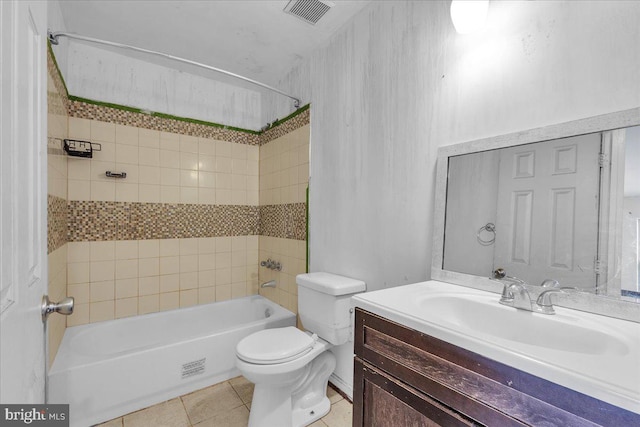 full bathroom with tiled shower / bath combo, vanity, tile patterned floors, and toilet