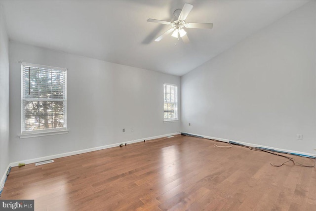 spare room with vaulted ceiling, ceiling fan, and hardwood / wood-style floors