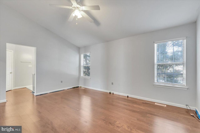 spare room featuring ceiling fan, wood-type flooring, and vaulted ceiling