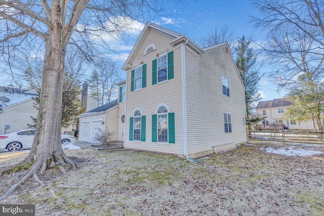 view of side of property with a garage