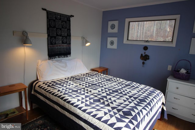 bedroom featuring light wood-type flooring and ornamental molding