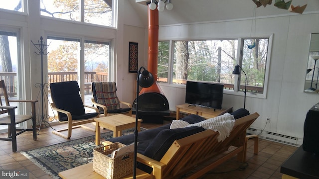 living room with vaulted ceiling, baseboard heating, and tile patterned floors