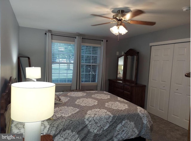 carpeted bedroom with ceiling fan and a closet