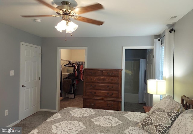 carpeted bedroom with ensuite bathroom, ceiling fan, a spacious closet, and a closet