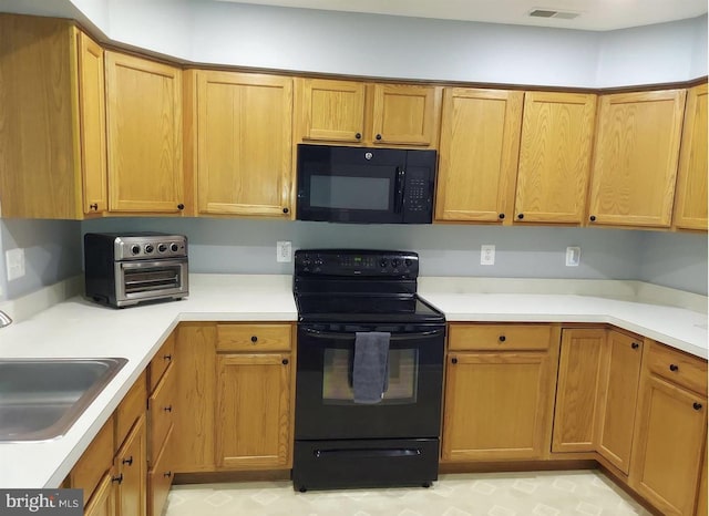 kitchen with black appliances and sink