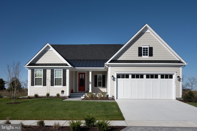 view of front of house featuring a front yard and a garage