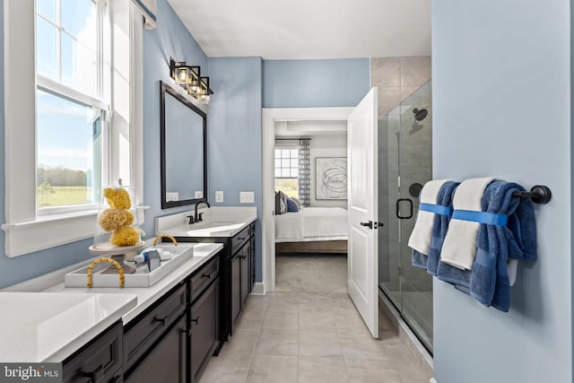 bathroom featuring a healthy amount of sunlight, a shower with door, and vanity