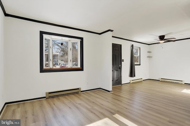 empty room featuring ceiling fan, a baseboard radiator, and light hardwood / wood-style floors