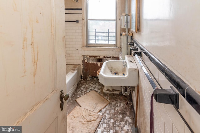 bathroom with a bathing tub and sink