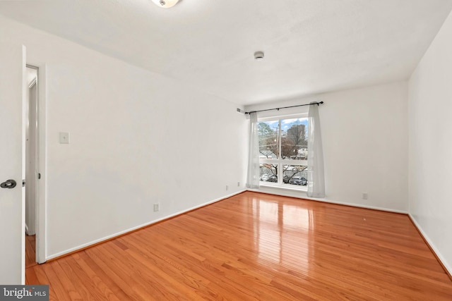 unfurnished room featuring hardwood / wood-style flooring