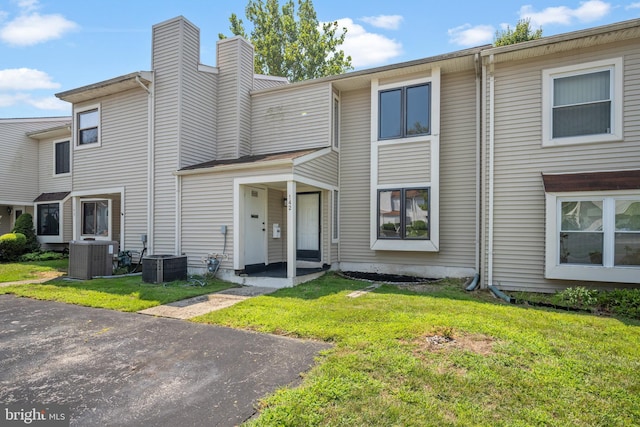 view of property with central AC and a front yard