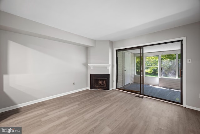 unfurnished living room with light hardwood / wood-style floors