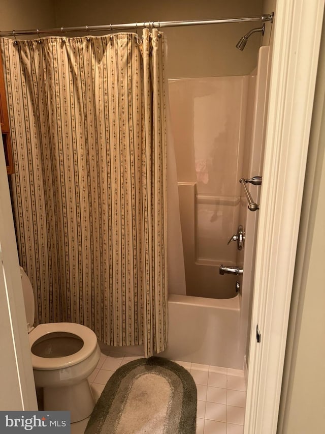 bathroom with tile patterned floors, toilet, and shower / bath combo