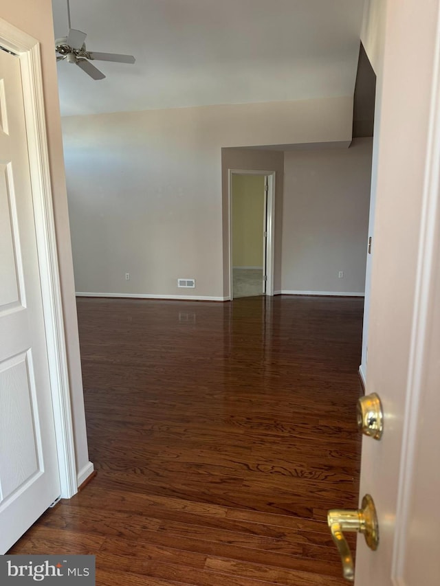 empty room featuring ceiling fan and dark hardwood / wood-style floors