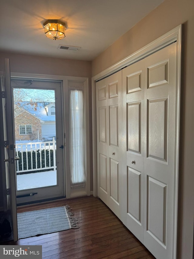 doorway with dark hardwood / wood-style floors