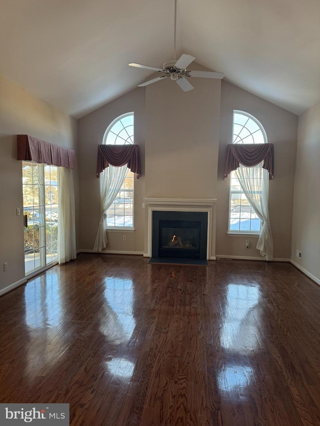 unfurnished living room featuring ceiling fan, vaulted ceiling, and dark hardwood / wood-style floors