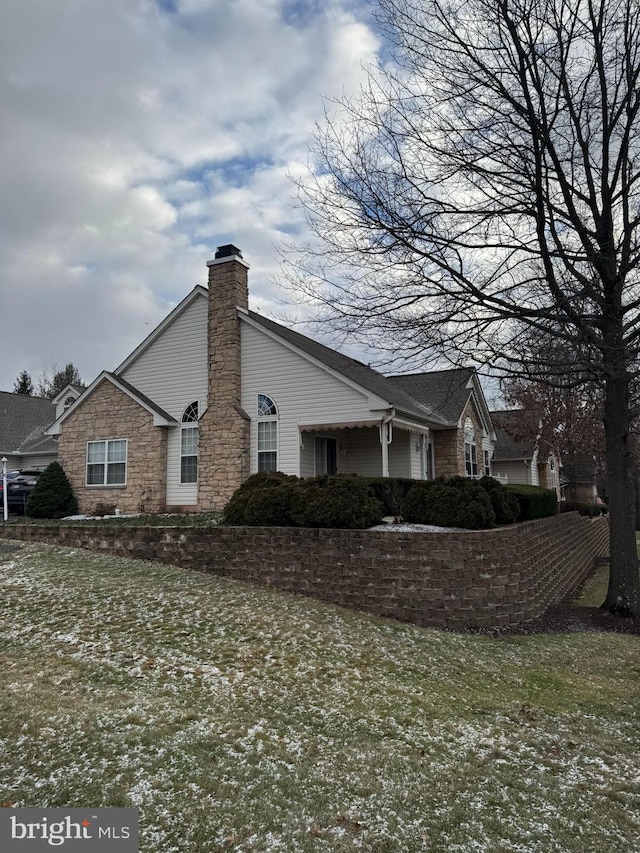 view of side of home featuring a lawn