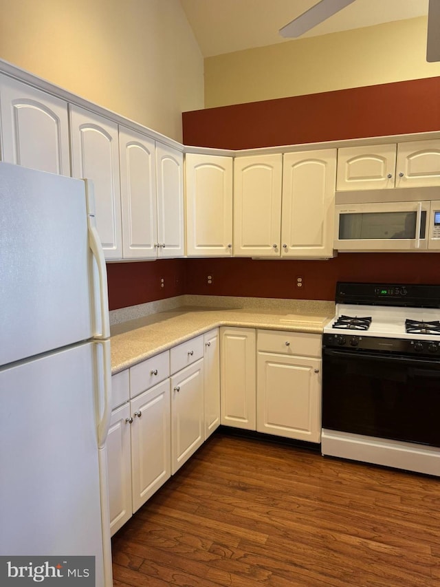 kitchen featuring white cabinetry, dark hardwood / wood-style flooring, and white appliances