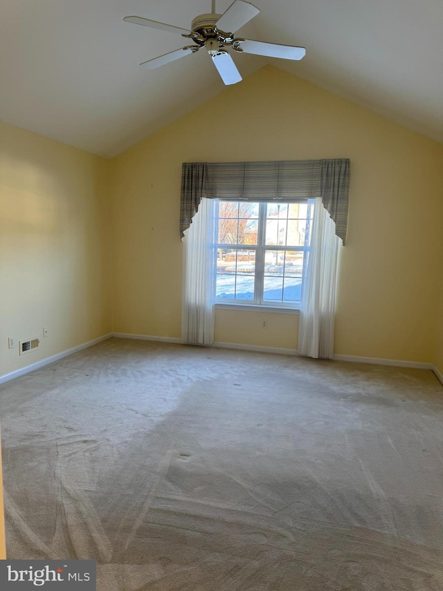 unfurnished room featuring ceiling fan, carpet, and lofted ceiling