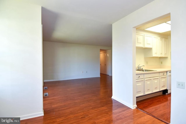 kitchen featuring sink, dark wood-type flooring, white cabinets, and dishwasher