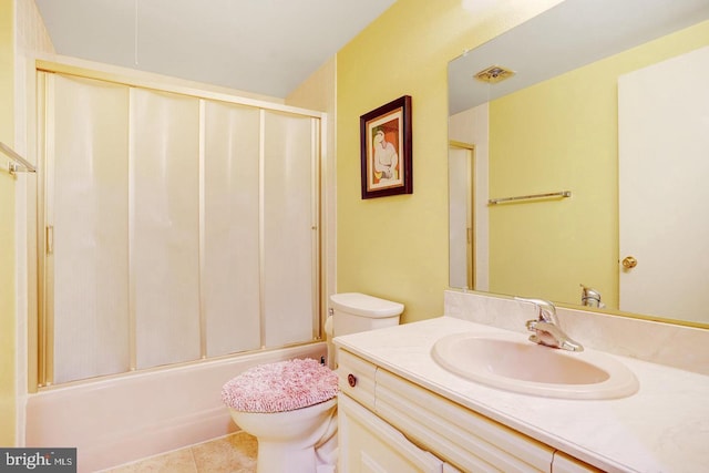 full bathroom featuring enclosed tub / shower combo, toilet, vanity, and tile patterned flooring