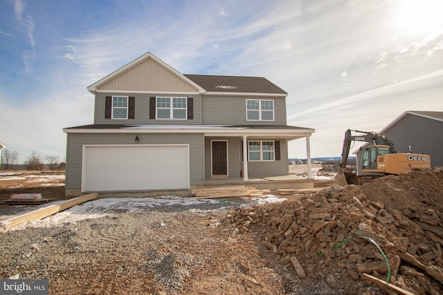 view of property featuring a porch and a garage