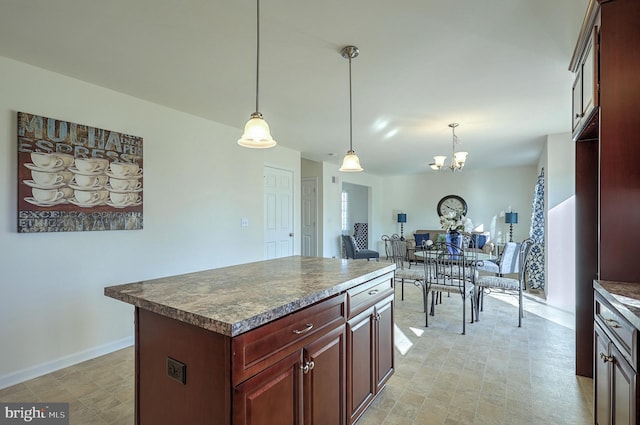 kitchen with pendant lighting, a center island, and an inviting chandelier