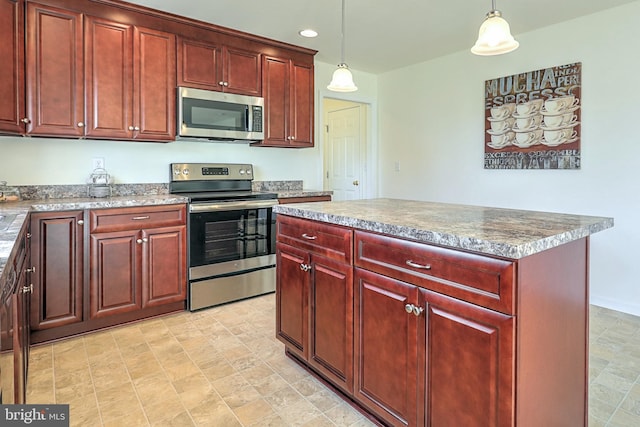 kitchen with a kitchen island, appliances with stainless steel finishes, and pendant lighting