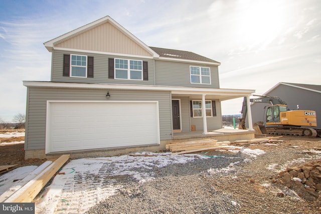 front of property with a porch and a garage