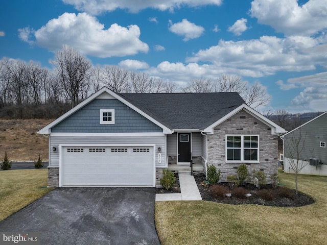 view of front of home with a garage and a front yard