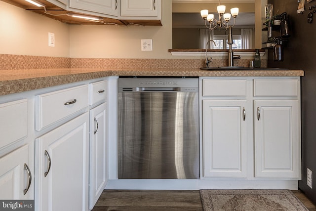 kitchen featuring sink, an inviting chandelier, decorative light fixtures, dishwashing machine, and white cabinets