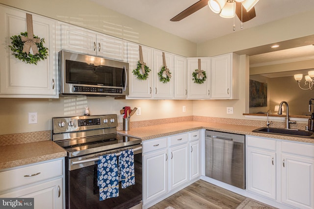 kitchen featuring white cabinetry, stainless steel appliances, light hardwood / wood-style floors, and sink