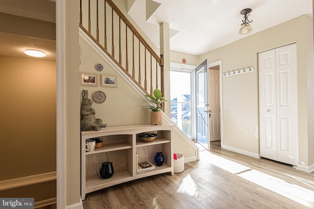 mudroom with hardwood / wood-style flooring and a textured ceiling