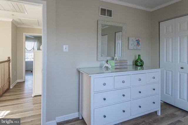 interior space featuring crown molding and light hardwood / wood-style floors