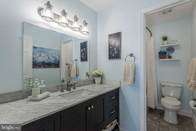 bathroom featuring vanity and toilet