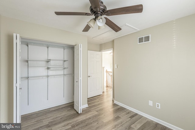 unfurnished bedroom featuring a closet, ceiling fan, and light wood-type flooring