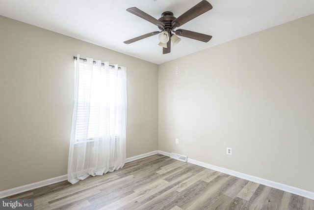 empty room featuring ceiling fan and light hardwood / wood-style flooring