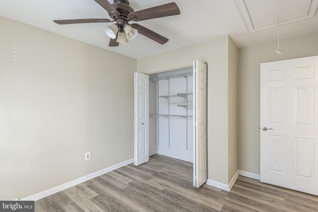 unfurnished bedroom featuring light hardwood / wood-style flooring, a closet, and ceiling fan