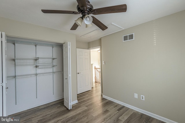 unfurnished bedroom with ceiling fan, wood-type flooring, and a closet