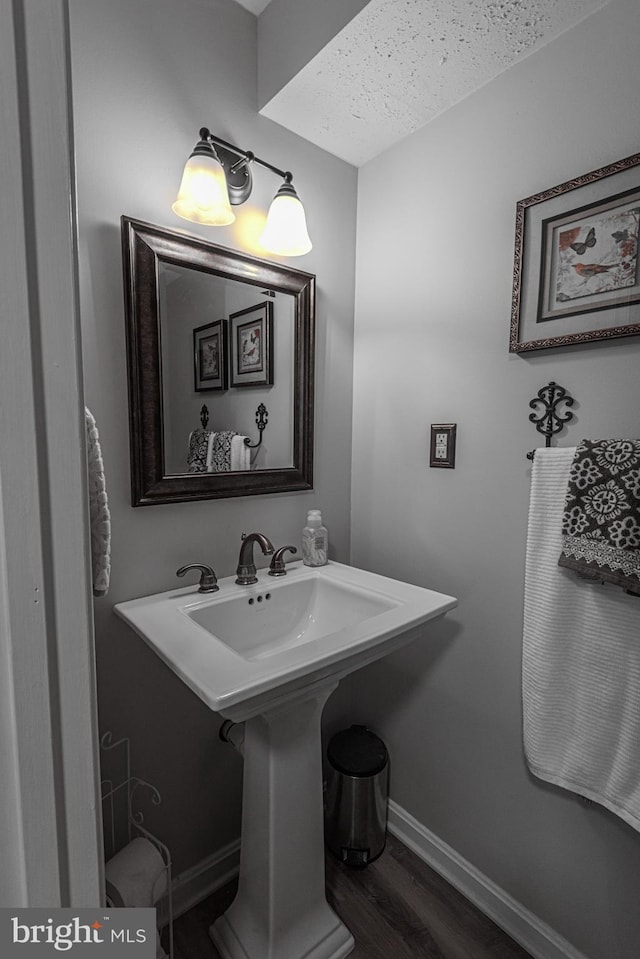 bathroom with hardwood / wood-style flooring and sink