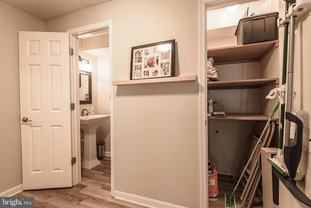 interior space featuring sink and light hardwood / wood-style flooring